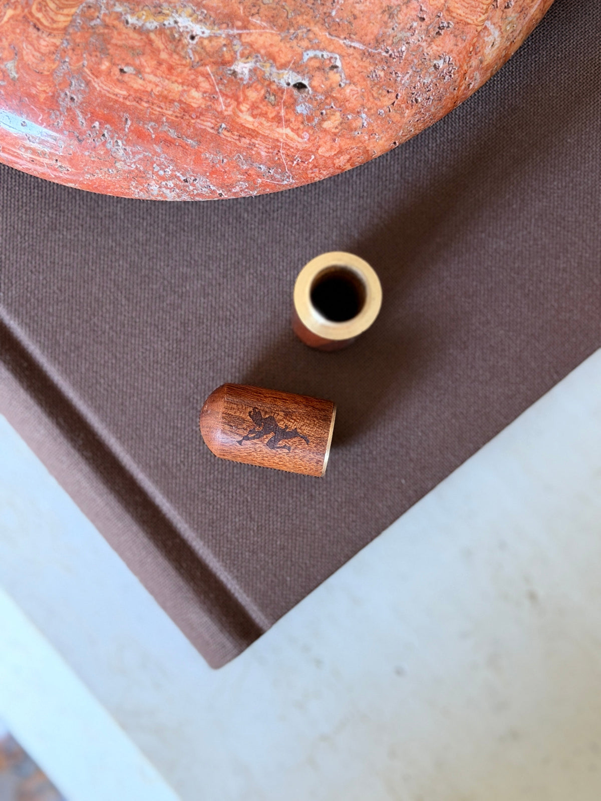 The Chateau Marmont holder shown disassembled, with the wood cap separated from the brass insert