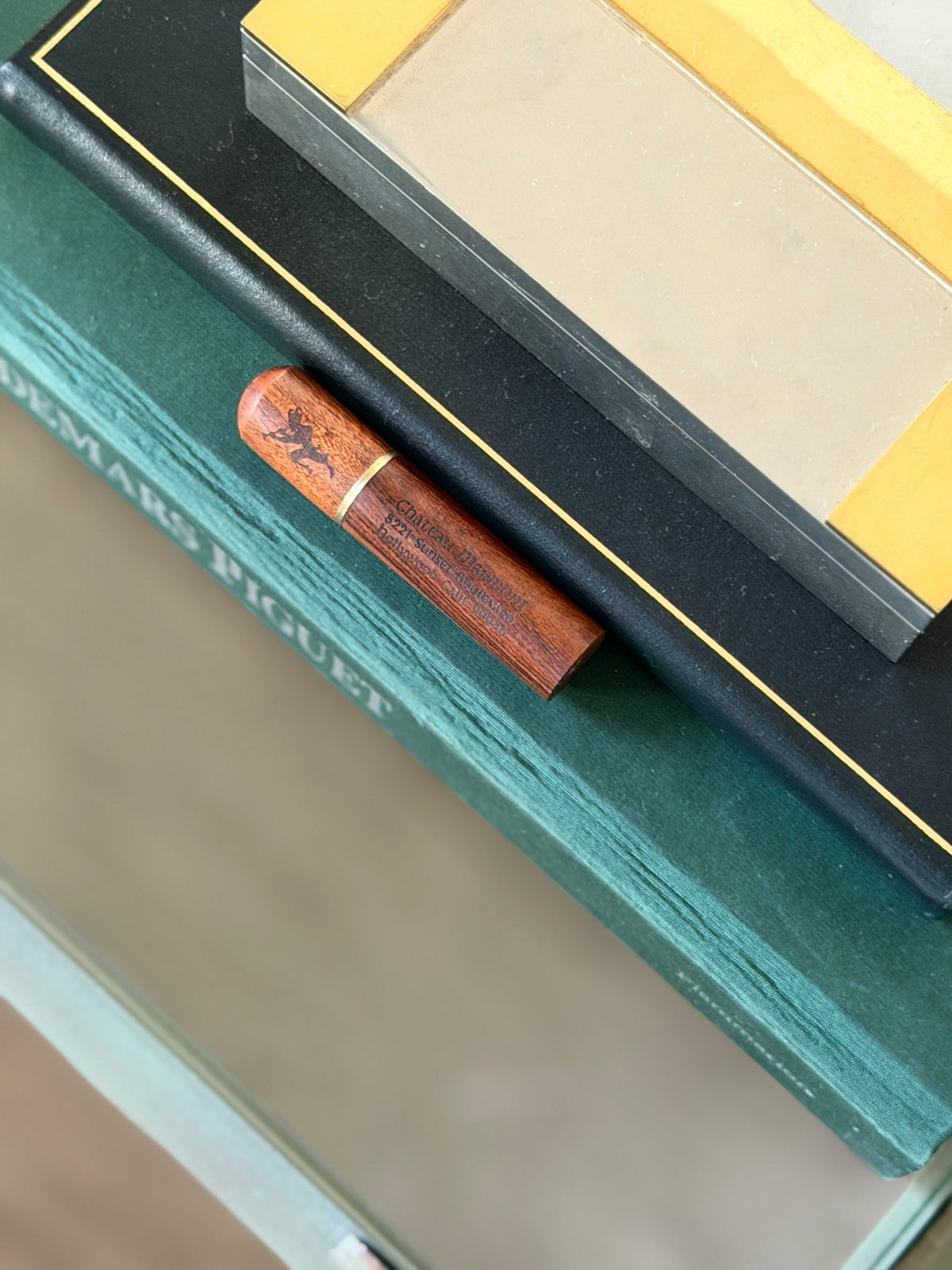 Logo view of the Chateau Marmont branding engraved on the wood holder