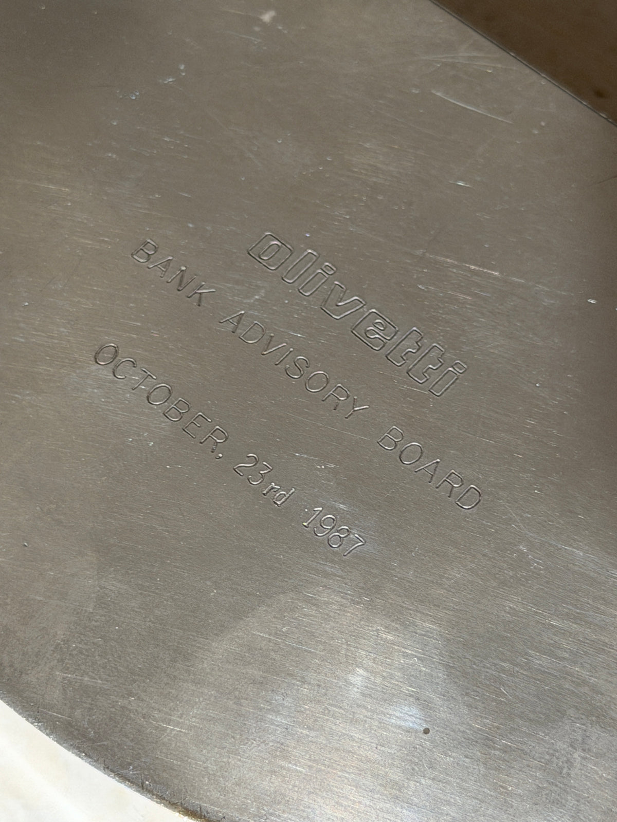 Close up of the engraving on the Olivetti box reading olivetti, Bank Advisory Board, October 23rd 1987