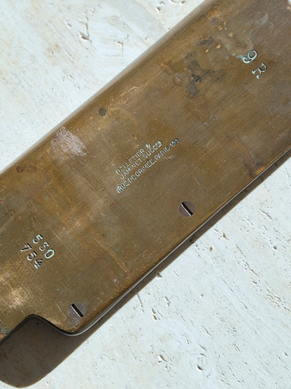 Close up of the stamp reading Pelletier and Jaminet Succs, Rue de Crimee, Paris, with size mark 9R, numbers 530 754, and slotted screws in the worn brass