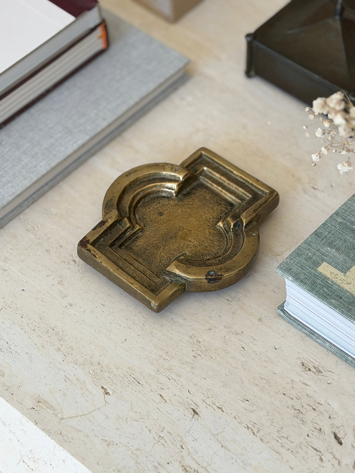 Collectors Gene vintage bronze geometric vide poche catchall dish with stepped architectural border on marble surface
