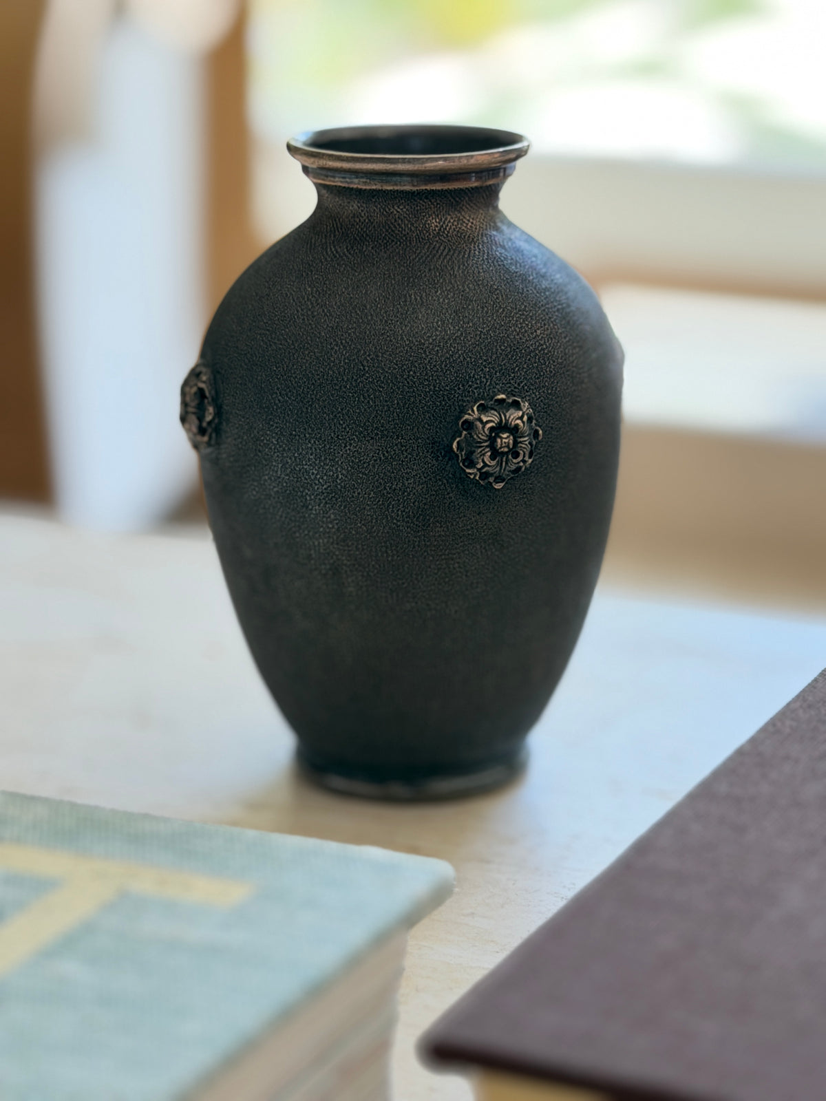 Angled view of the Buccellati silver vase against natural light