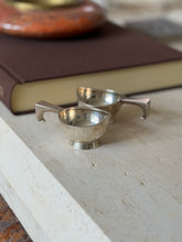 Another angle of the two dishes together, showing the shallow bowl form and squared handle detail