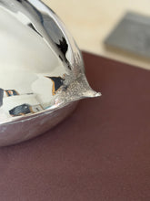 Close up of the chestnut box tip, the finely textured silver shell rising to a small pointed stem above the polished base