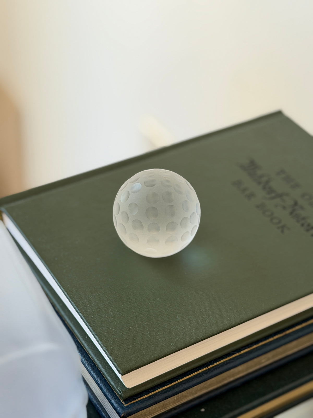 High angle view of 1.25 inch dimpled frosted crystal golf ball paperweight available at Collectors Gene