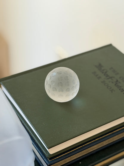 High angle view of 1.25 inch dimpled frosted crystal golf ball paperweight available at Collectors Gene