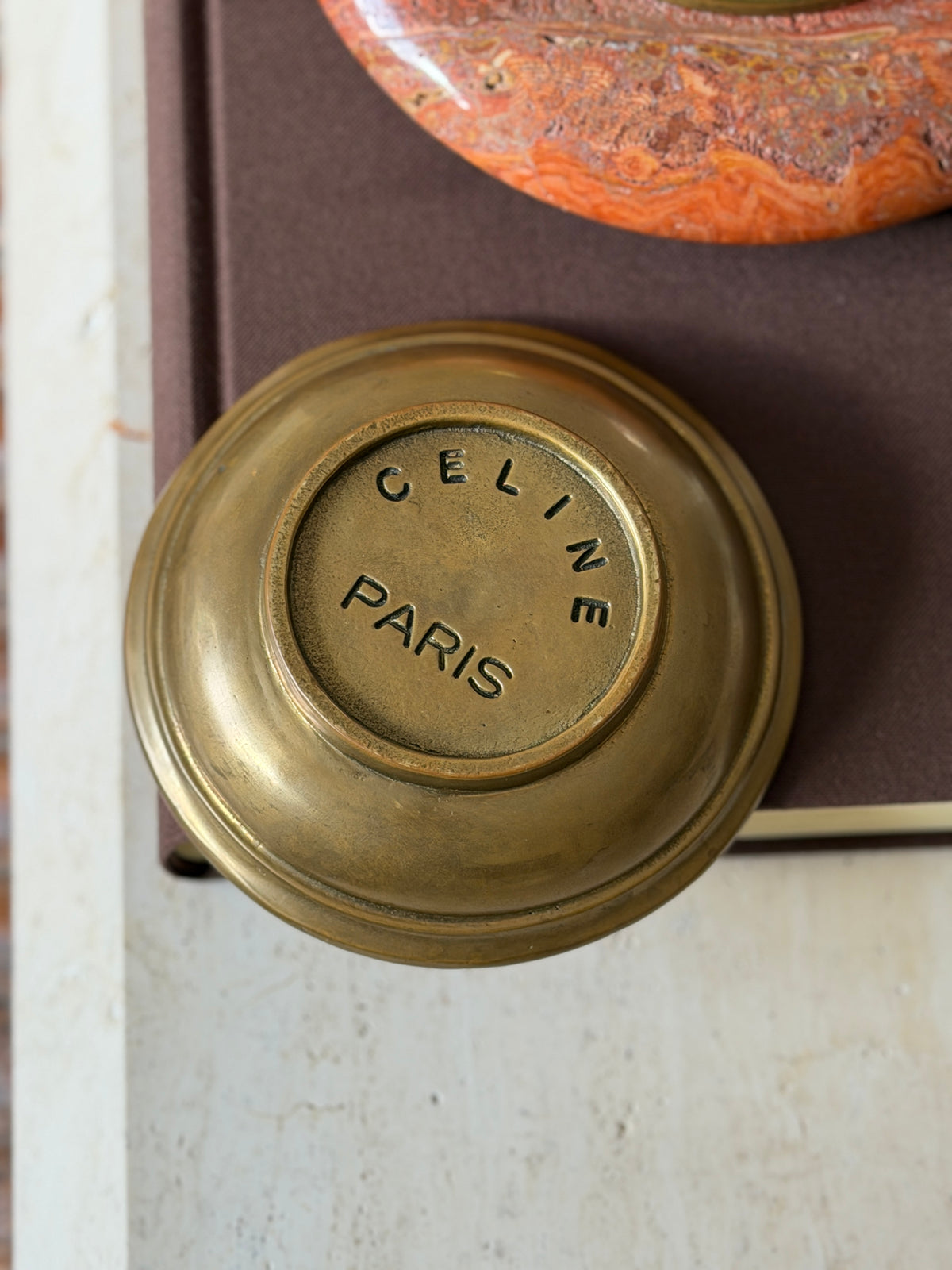 The dish turned over, showing Celine Paris stamped into the brass base