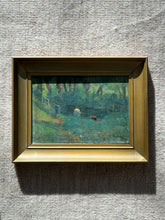 Angled close view of the woodland pond painting in sunlight, showing textured brushwork, a figure in blue by a rustic rail, and a plank footbridge at right