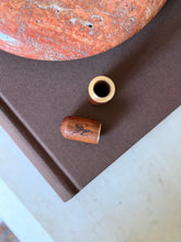 The Chateau Marmont holder shown disassembled, with the wood cap separated from the brass insert