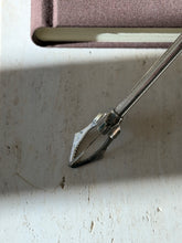 Close up of the serrated jaws stamped Christofle France with small hallmarks, the engine turned shaft above