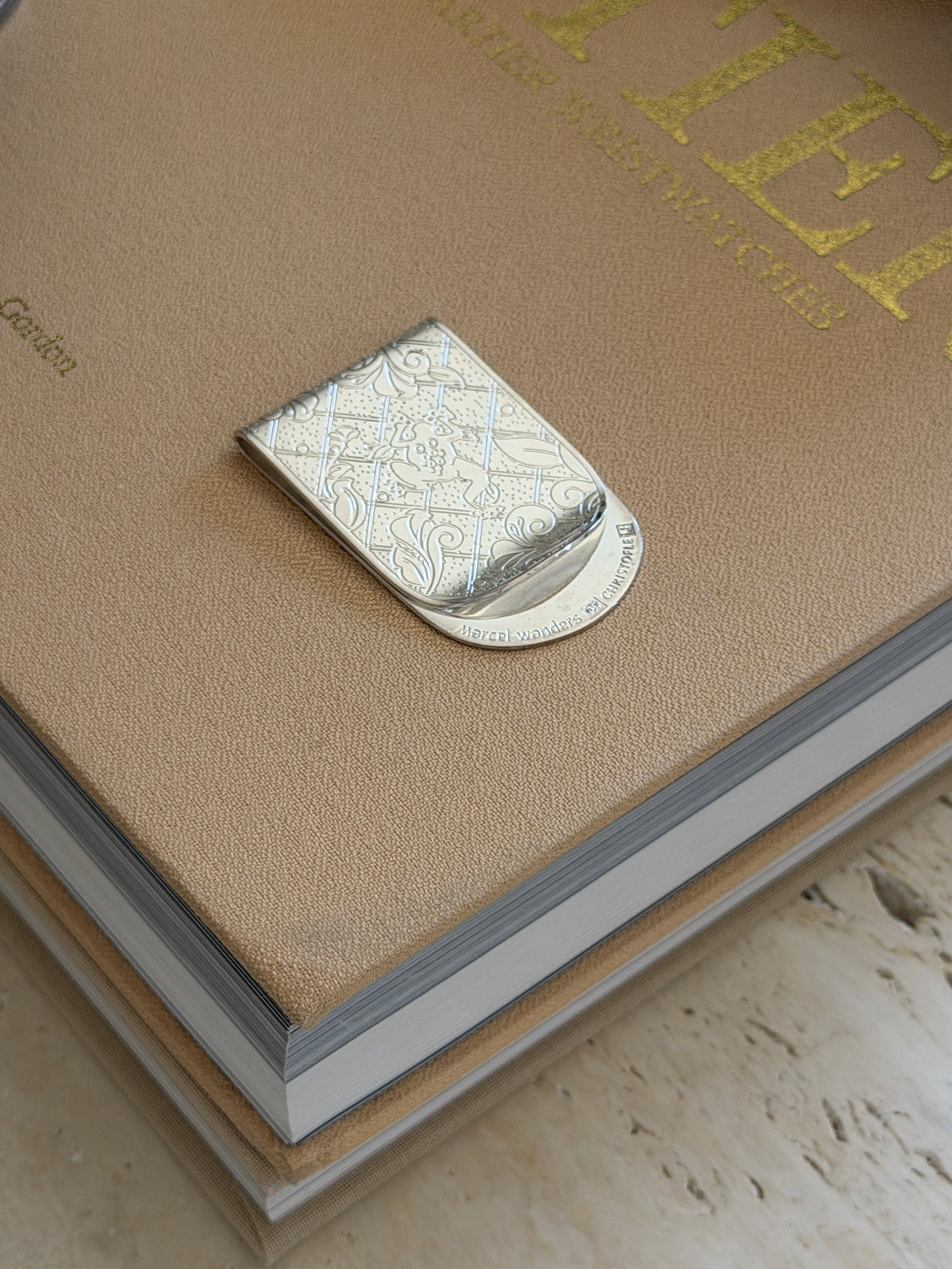 High angle view of Marcel Wanders engraved botanical silver money clip available at Collectors Gene