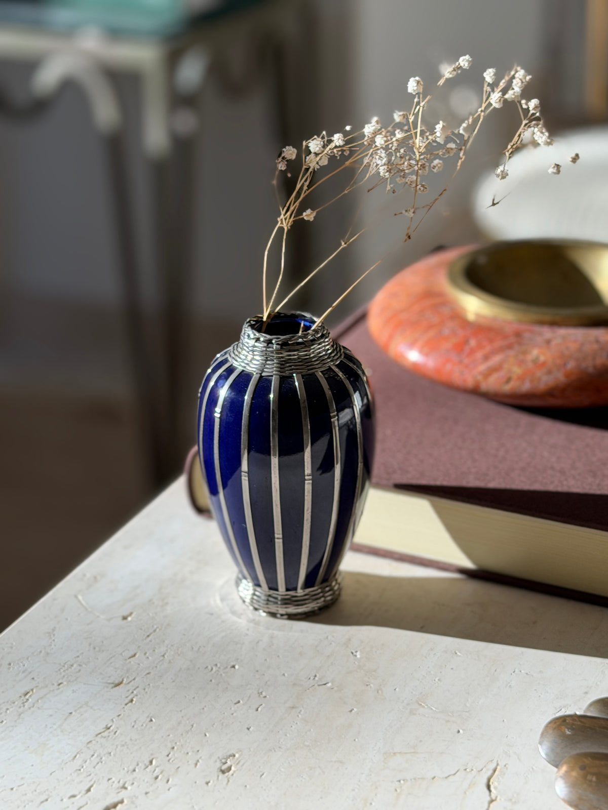 Cobalt blue vase holding sprigs of dried baby&