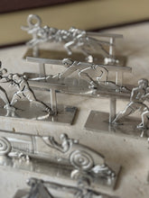 Close detail of the fencer and boxing knife rests, a small stamped maker&