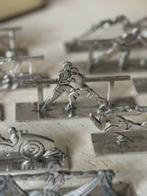Boxing knife rest in focus, two fighters in a clinch against the rail, the race car and rugby rests softly blurred
