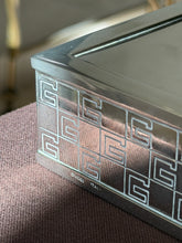 Close up of the corner of the Gucci vide poche, showing the engraved G pattern and the stamped GUCCI ITALY mark