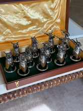Closer overhead view of the cups lined up in their compartments, showing the mix of hare, hound, horse, boar, and stag heads