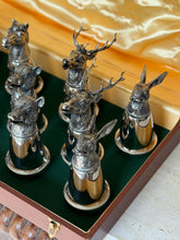 Close-up of a cluster of cups including a horse, a boar, two stags with large antlers, and a hare, showing the finely chased fur texture