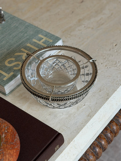 Angled top-down view of the Hermes crystal caviar service beside a stack of books