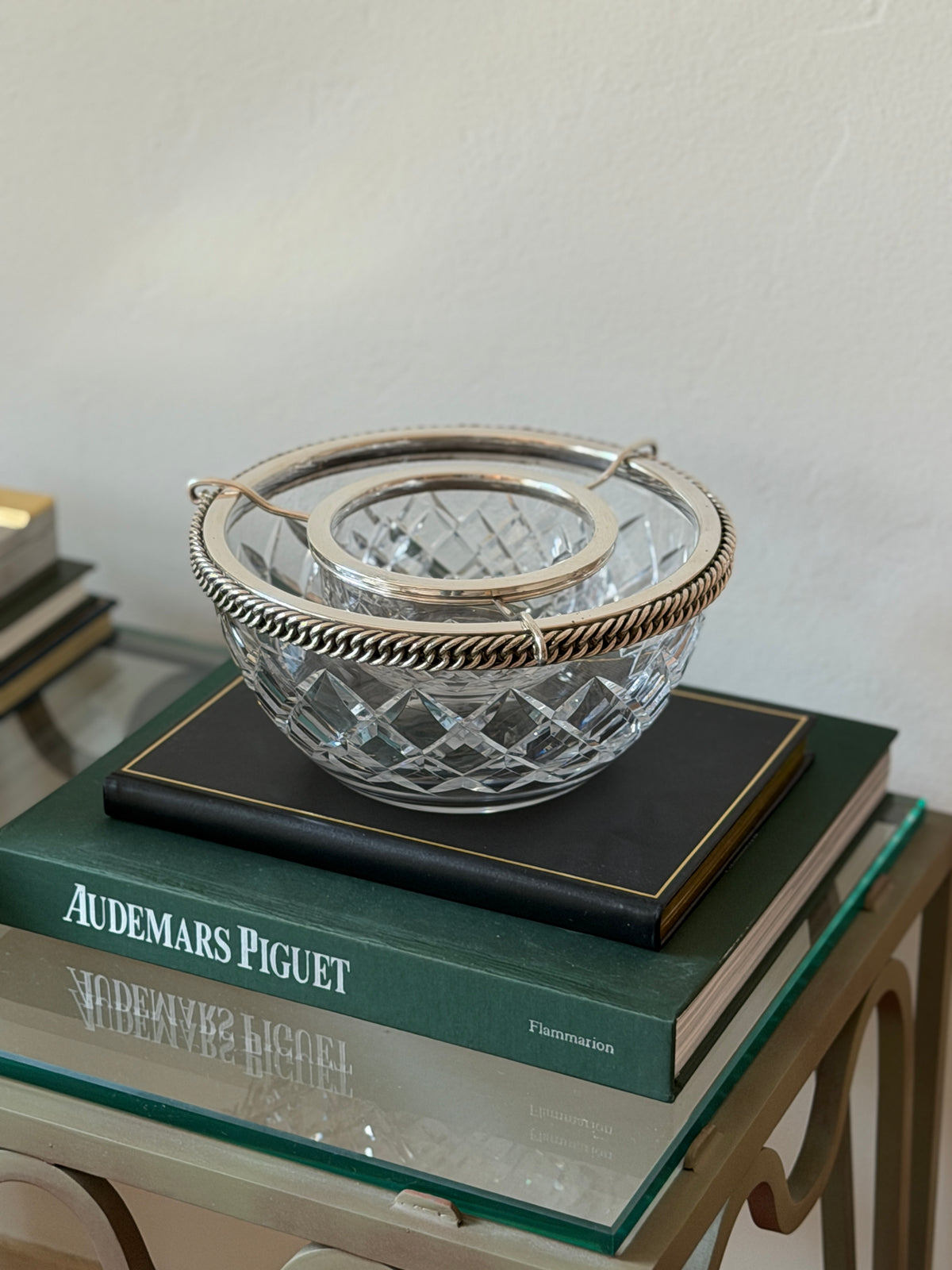 Hermes caviar service on a black book, set against a plain wall
