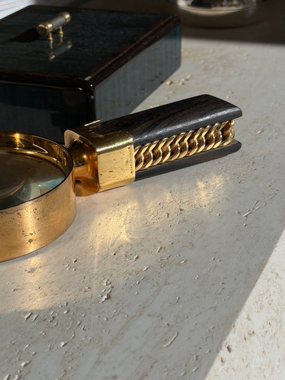 Close up of the gilt collar stamped HERMES PARIS where it meets the ebony handle and the curb chain set along its side
