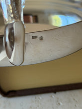 Close-up of the hallmark stamps at the base of the horse head handle