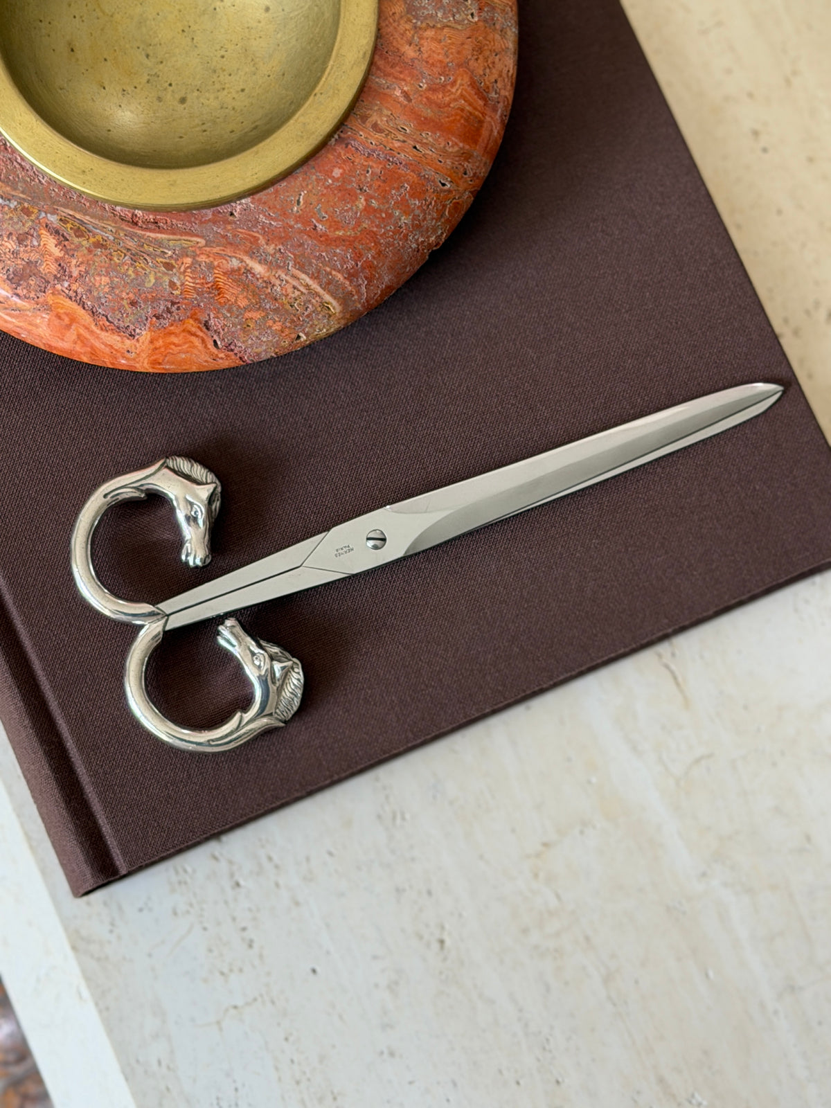 Closer overhead view showing the full length of the blades with the Hermes Paris signature near the pivot screw