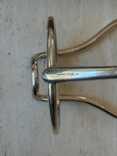 Close view of the wine caddy snaffle bar stamped HERMES PARIS, the polished ring passing through the cheek piece