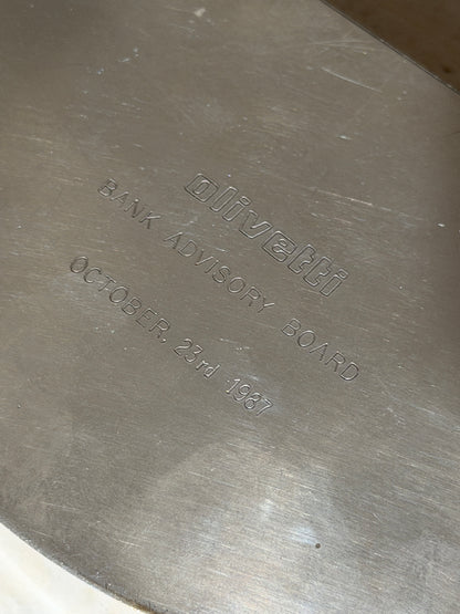 Close up of the engraving on the Olivetti box reading olivetti, Bank Advisory Board, October 23rd 1987