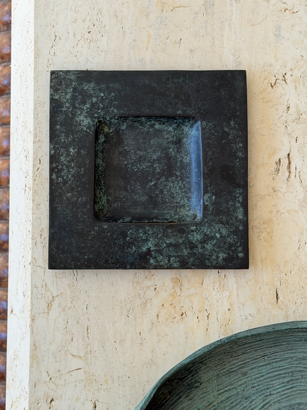 Top-down view of square vintage bronze vide poche showing blue-green aged patina and flat border detail