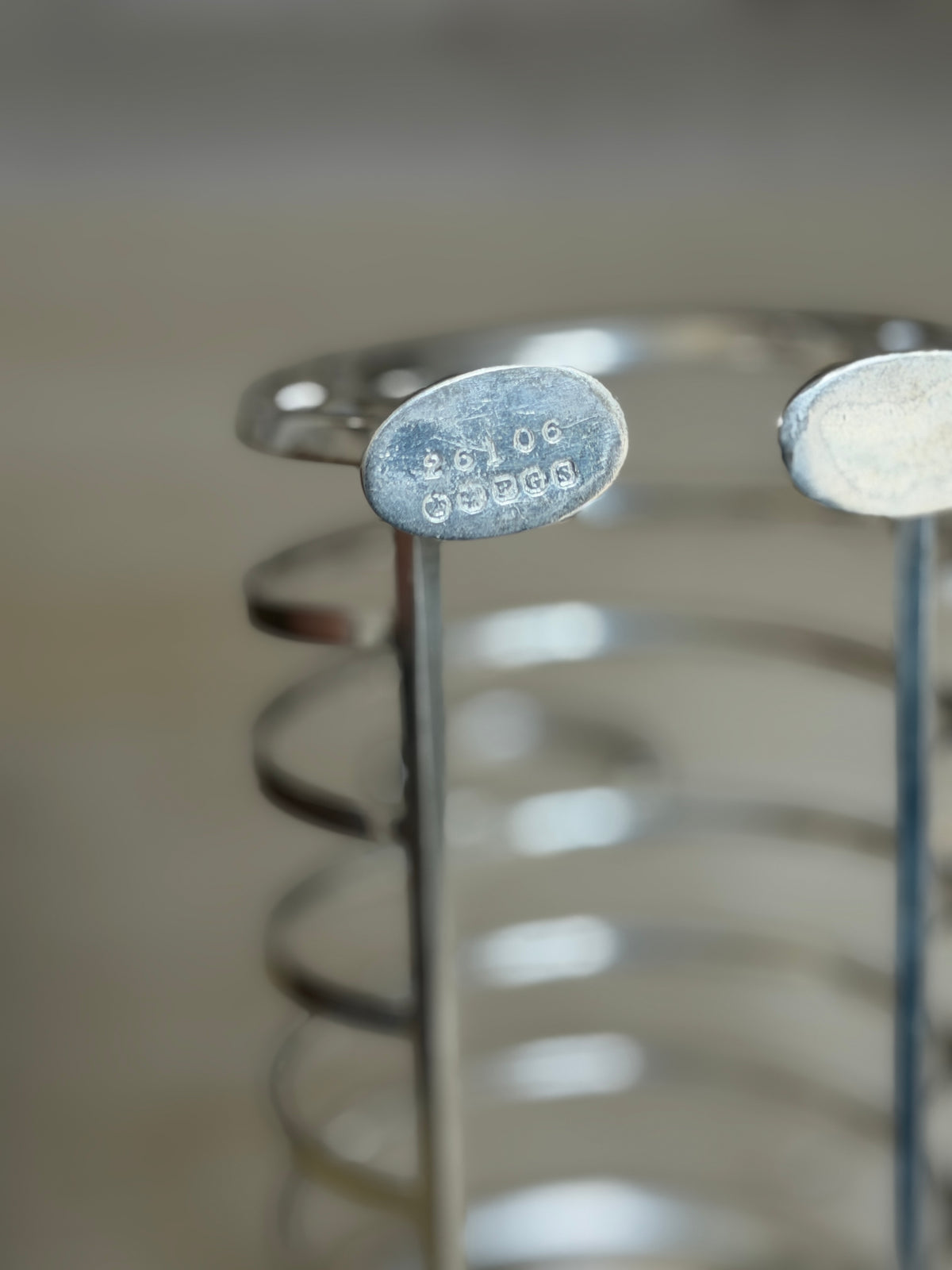 Close up of a toast rack foot pad stamped with maker&