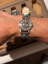 Alternate wrist shot view of vintage Heuer black dial chronograph with turquoise sterling silver cuff bracelet from Collectors Gene
