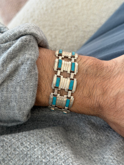 Vintage Narvaez Taxco sterling silver and turquoise bracelet worn on the wrist, wide stepped silver panels set with rectangular turquoise stones